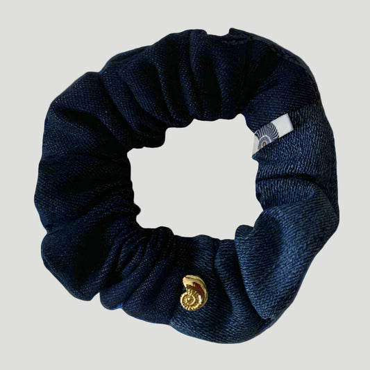 Light to dark navy blue denim scrunchie with a gold plated shell bead. handmade using new and upcycled materials. 